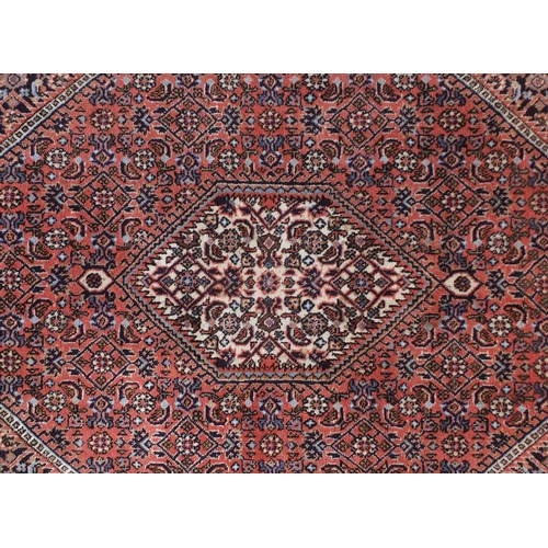 1325 - Iranian wool rug with all over floral design onto a predominantly blue and red ground, 146cm x 91cm