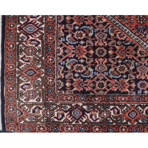 1325 - Iranian wool rug with all over floral design onto a predominantly blue and red ground, 146cm x 91cm