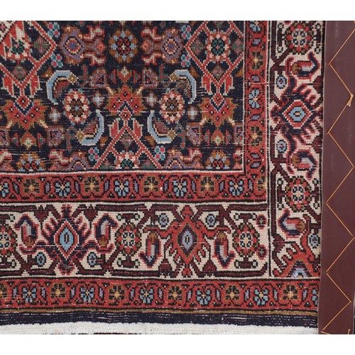 1325 - Iranian wool rug with all over floral design onto a predominantly blue and red ground, 146cm x 91cm