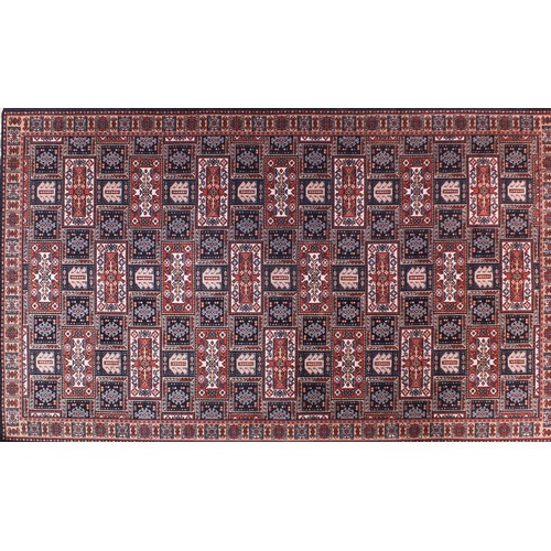 1330 - Persian rug with all over geometric design onto a predominantly blue and red ground, 225cm x 138cm