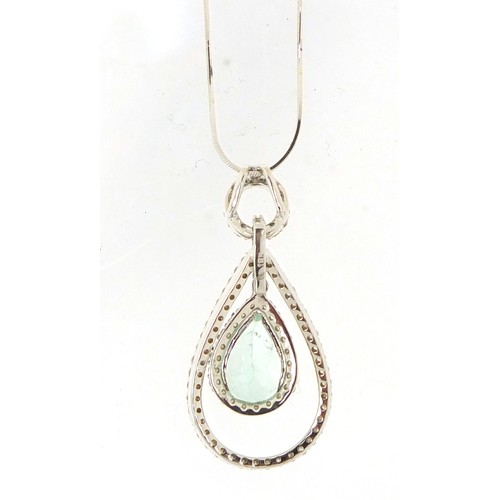 12 - 18ct white gold Columbian emerald and diamond surround pendant, 4cm in length on an 18ct white gold ... 