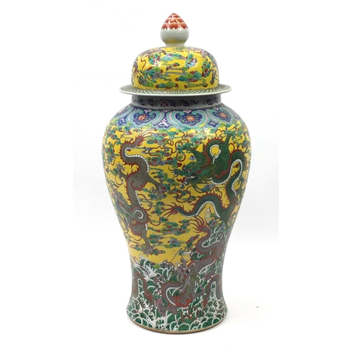 217 - Floor standing Chinese porcelain baluster vase and cover, hand painted with dragons amongst clouds a... 