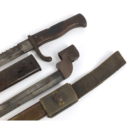 690 - German military interest Mausel sawback bayonet with scabbard by Waffenfabrik and one other, the lar... 