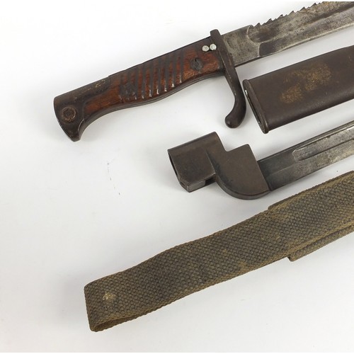690 - German military interest Mausel sawback bayonet with scabbard by Waffenfabrik and one other, the lar... 