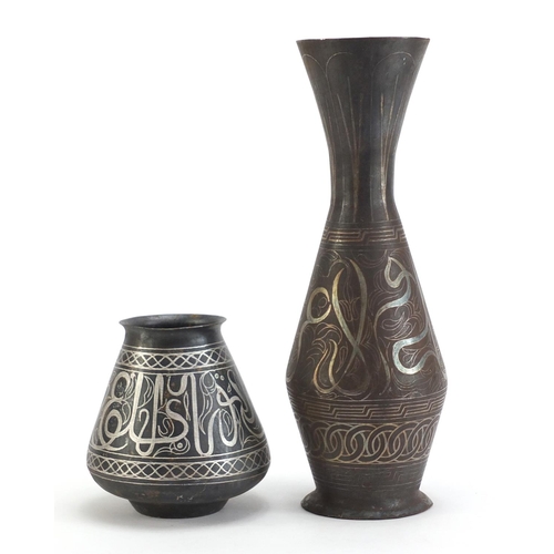 3786 - Two Indian Bidri ware vases decorated with calligraphy and foliate motifs, the largest 32cm high