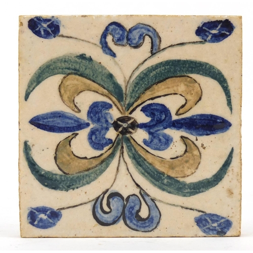 207 - Attributed to Bernard Leach, St Ives studio pottery tile, hand painted with a stylised floral design... 