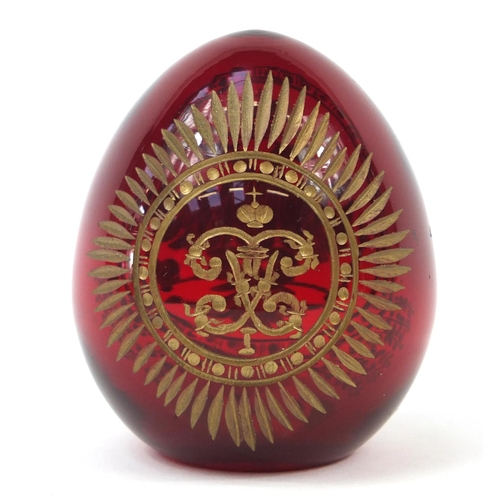142 - Russian ruby glass egg in the style of Faberge, 6cm high
