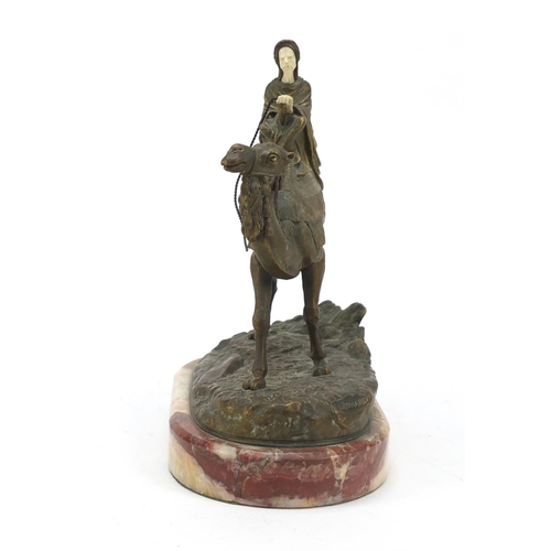 163 - Agathon Leonard, French Art Nouveau gilt bronze and ivory figure of an Arab on camelback, raised on ... 