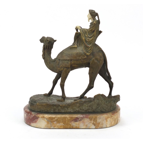 163 - Agathon Leonard, French Art Nouveau gilt bronze and ivory figure of an Arab on camelback, raised on ... 