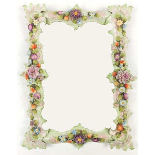 100 - Continental floral encrusted porcelain wall mirror with wood back and bevelled plate, 44cm x 35cm