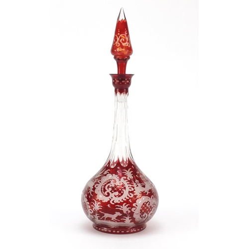 136 - Bohemian ruby glass decanter etched with wild animals and flowers, 34.5cm high