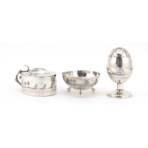 3085 - Egyptian silver niello work three piece cruet depicting temples and sailing boats, the largest 7cm h... 