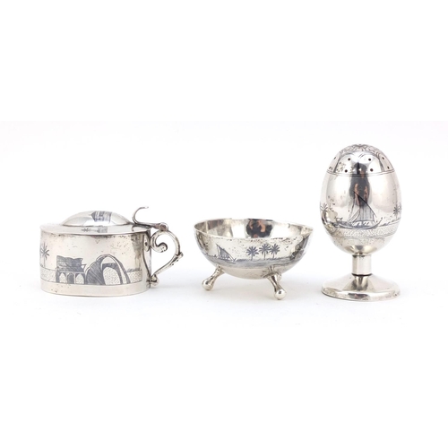 3085 - Egyptian silver niello work three piece cruet depicting temples and sailing boats, the largest 7cm h... 