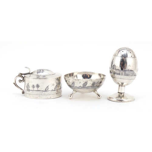 3085 - Egyptian silver niello work three piece cruet depicting temples and sailing boats, the largest 7cm h... 