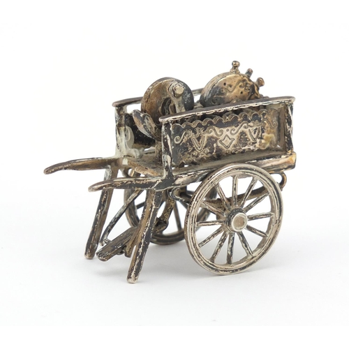 3042 - Medusa Oro, Italian miniature silver model of a knife sharpener's cart with moving parts, 6cm in len... 