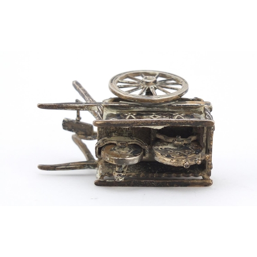 3042 - Medusa Oro, Italian miniature silver model of a knife sharpener's cart with moving parts, 6cm in len... 