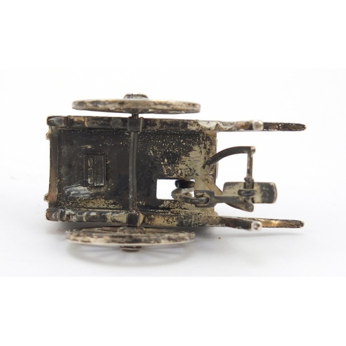 3042 - Medusa Oro, Italian miniature silver model of a knife sharpener's cart with moving parts, 6cm in len... 