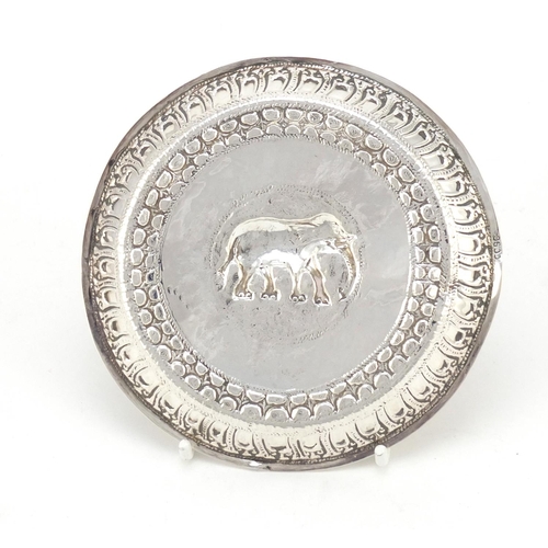 3079 - Burmese silver coloured metal dish embossed with a elephant, 11cm in diameter, 53.5g