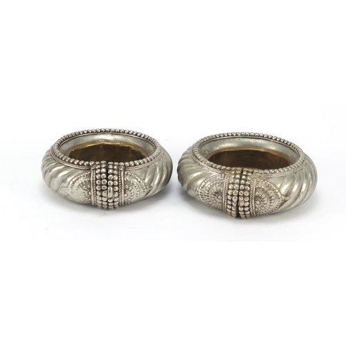 317 - Two African silver coloured metal slave anklets, the largest 13cm in diameter