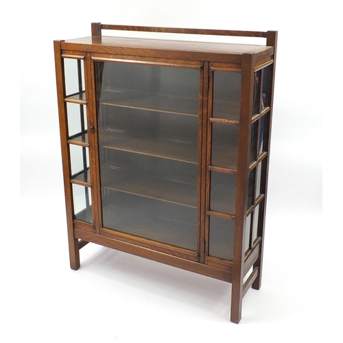 1485 - Manner of Liberty & Co, Arts & Crafts oak glazed display cabinet with three shelves, 139cm H x 109cm... 