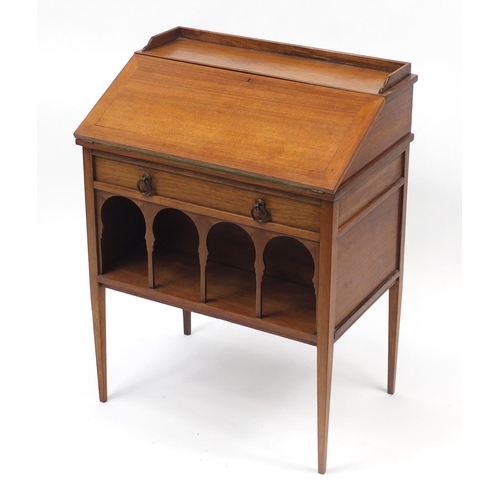 1486 - Liberty & Co, Arts & Crafts walnut student's bureau with a fall above a drawer and open shelf, 83cm ... 