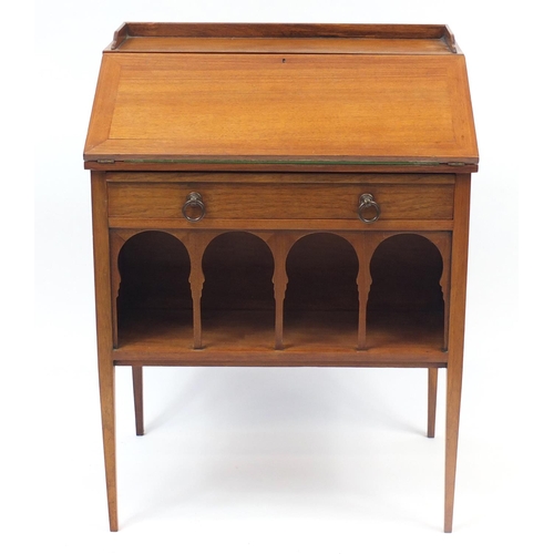 1486 - Liberty & Co, Arts & Crafts walnut student's bureau with a fall above a drawer and open shelf, 83cm ... 