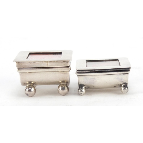 3060 - Two Victorian and later silver stamp boxes with hinged lids, each raised on four ball feet, Birmingh... 