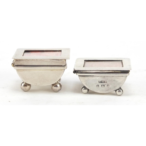 3060 - Two Victorian and later silver stamp boxes with hinged lids, each raised on four ball feet, Birmingh... 