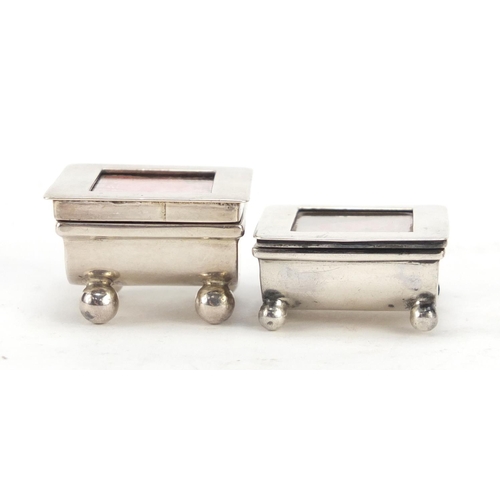 3060 - Two Victorian and later silver stamp boxes with hinged lids, each raised on four ball feet, Birmingh... 