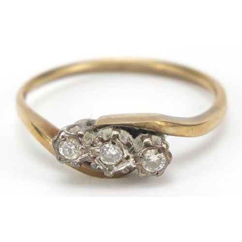 2366 - 9ct gold diamond three stone crossover ring, size O, 2.2g