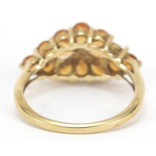 2338 - 9ct gold orange stone flower head ring, size O, 2.9g