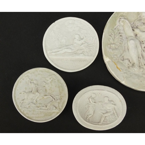 24 - Seven Italian Grand Tour plaster cameos, the largest 7.5cm in diameter