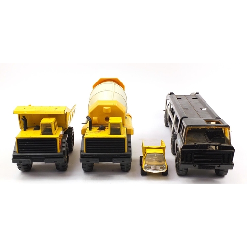 1760 - Four large Tonka tinplate vehicles and a smaller example including car transporter and dump truck, t... 