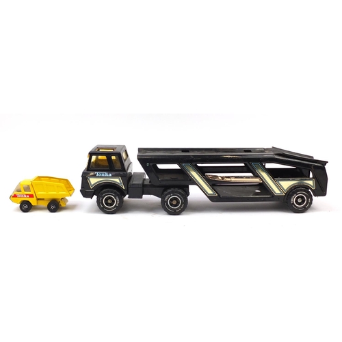 1760 - Four large Tonka tinplate vehicles and a smaller example including car transporter and dump truck, t... 