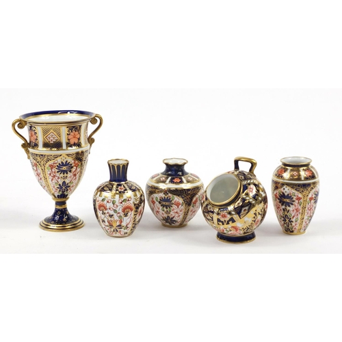 94 - Royal Crown Derby Old Imari comprising a trophy vase, scuttle and three other vases, the largest 12.... 