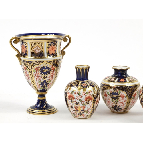 94 - Royal Crown Derby Old Imari comprising a trophy vase, scuttle and three other vases, the largest 12.... 