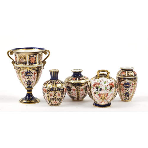 94 - Royal Crown Derby Old Imari comprising a trophy vase, scuttle and three other vases, the largest 12.... 