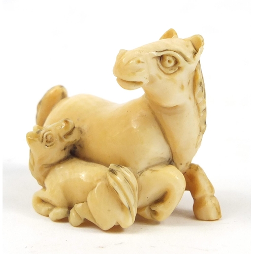 519 - Japanese carved ivory Netsuke of two horses, 4cm high