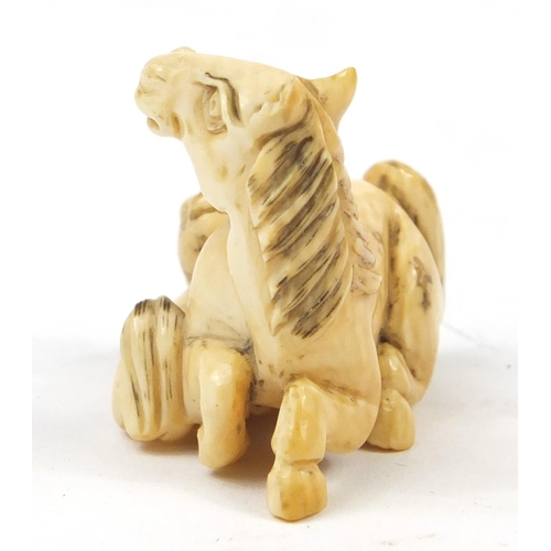 519 - Japanese carved ivory Netsuke of two horses, 4cm high