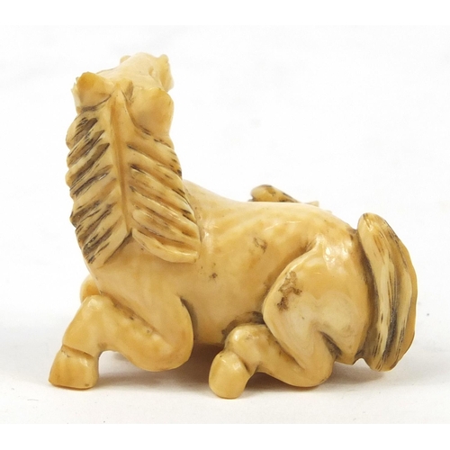 519 - Japanese carved ivory Netsuke of two horses, 4cm high