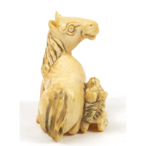 519 - Japanese carved ivory Netsuke of two horses, 4cm high