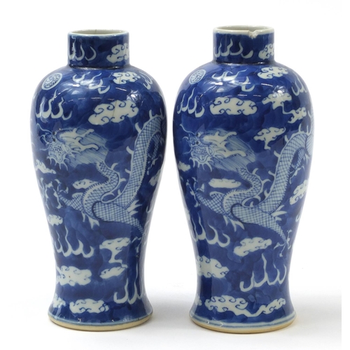 233 - Pair of Chinese blue and white porcelain baluster vases hand painted with dragons amongst clouds, fo... 