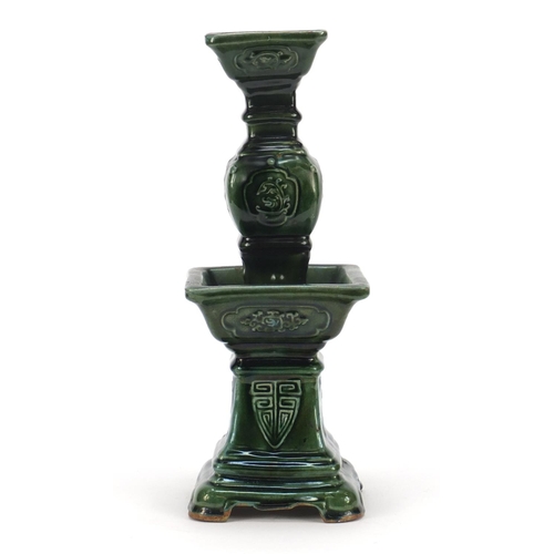 3778 - Large Chinese archaic style candlestick having a green glaze, 38cm high