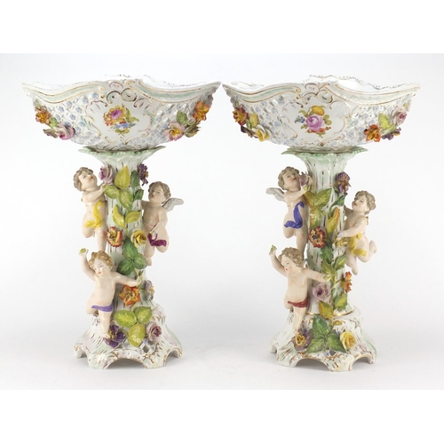 99 - Dresden, large pair of floral encrusted porcelain centrepieces with pierced baskets on naturalistic ... 