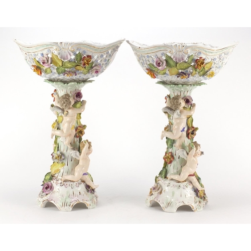 99 - Dresden, large pair of floral encrusted porcelain centrepieces with pierced baskets on naturalistic ... 