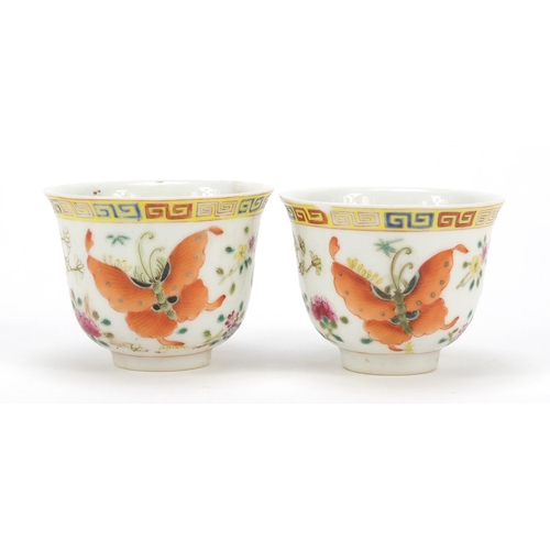 115 - Pair of Chinese porcelain tea cups, each finely hand painted in the famille rose palette with butter... 