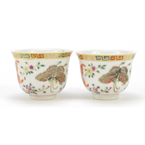 115 - Pair of Chinese porcelain tea cups, each finely hand painted in the famille rose palette with butter... 