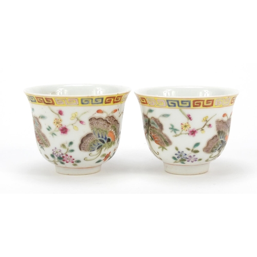 115 - Pair of Chinese porcelain tea cups, each finely hand painted in the famille rose palette with butter... 