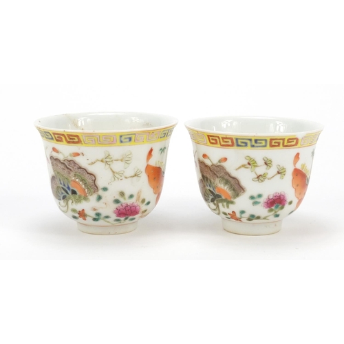 115 - Pair of Chinese porcelain tea cups, each finely hand painted in the famille rose palette with butter... 