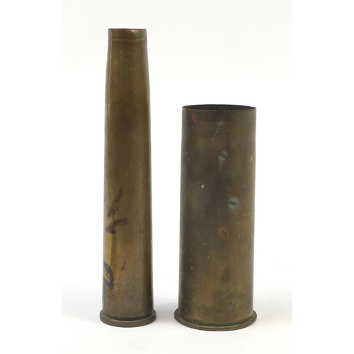 2047 - Militaria including a German gun holster and two trench shells, the largest 31cm high